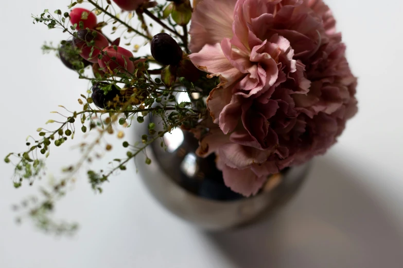 a vase with pink flowers on top of it