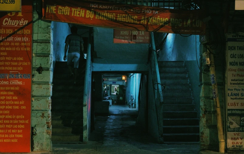 a hallway is shown with stairs and signs