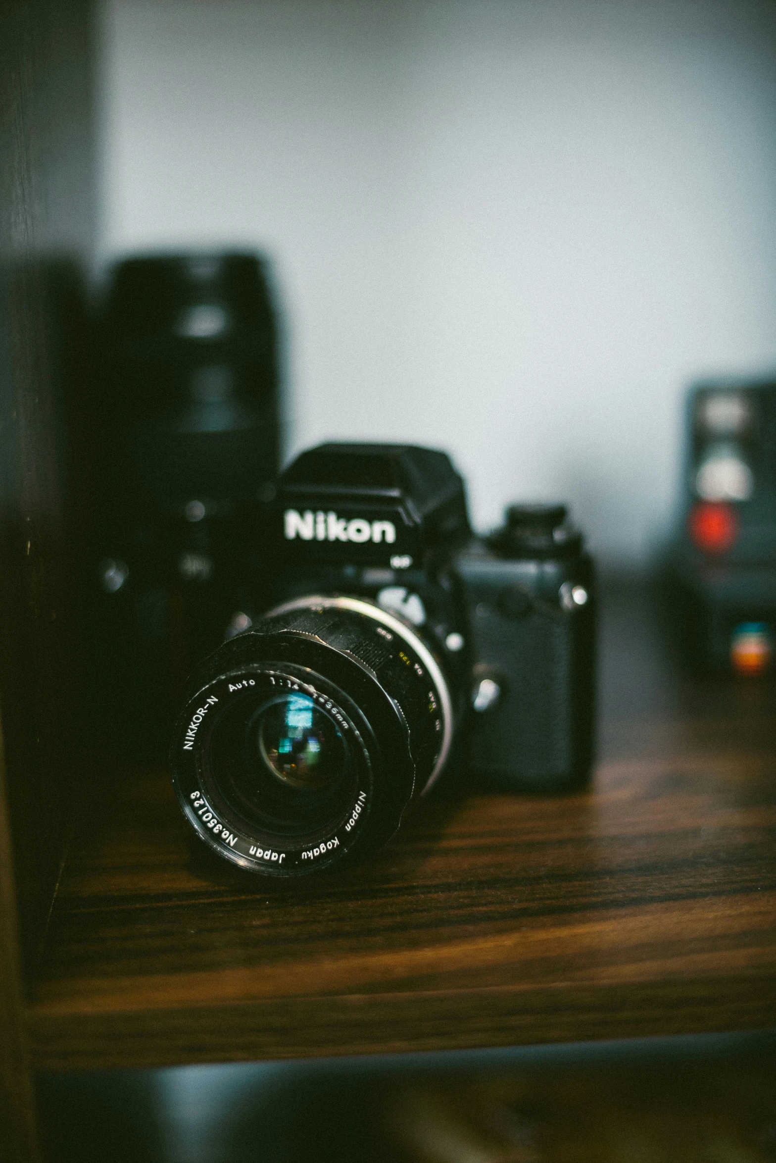 a camera sitting on top of a table next to an analog camera