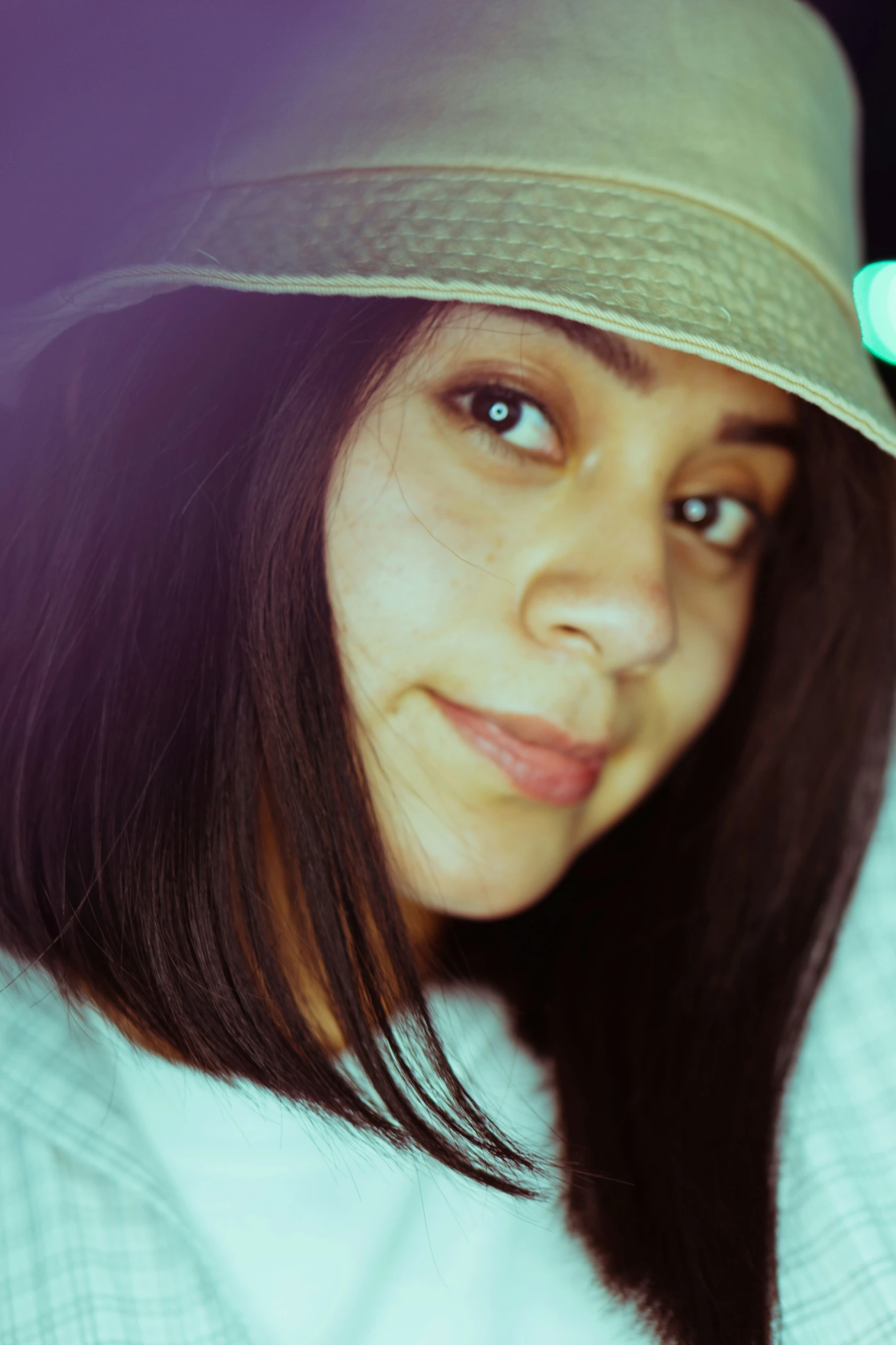 a woman with a hat in a light room