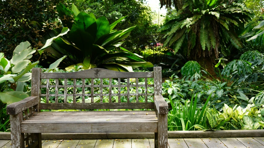 a wooden bench sitting on top of a wood patio