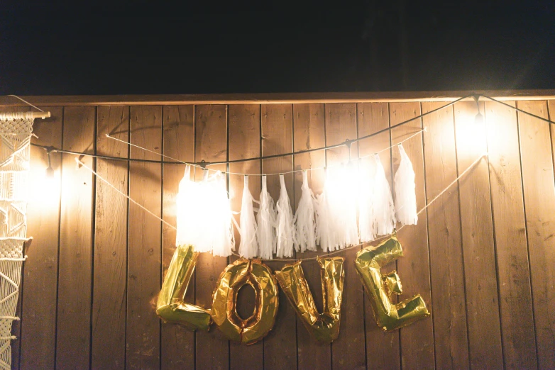 this is a po of a love banner with balloons and streamers hanging from strings