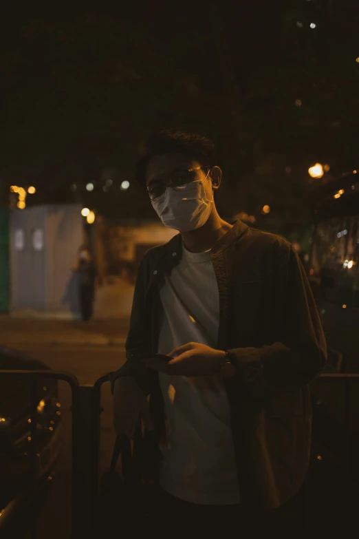 a man is standing next to a fence in the street