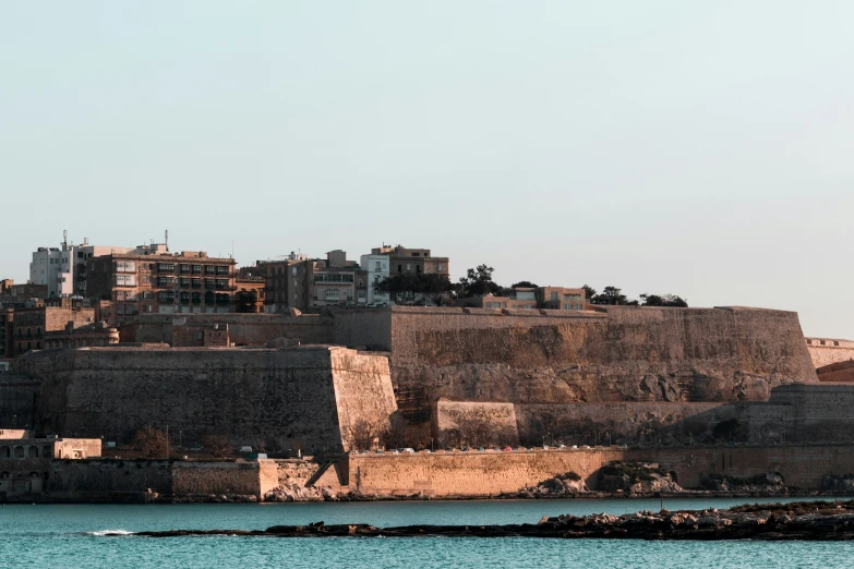 an old city overlooks the waters near its ruins