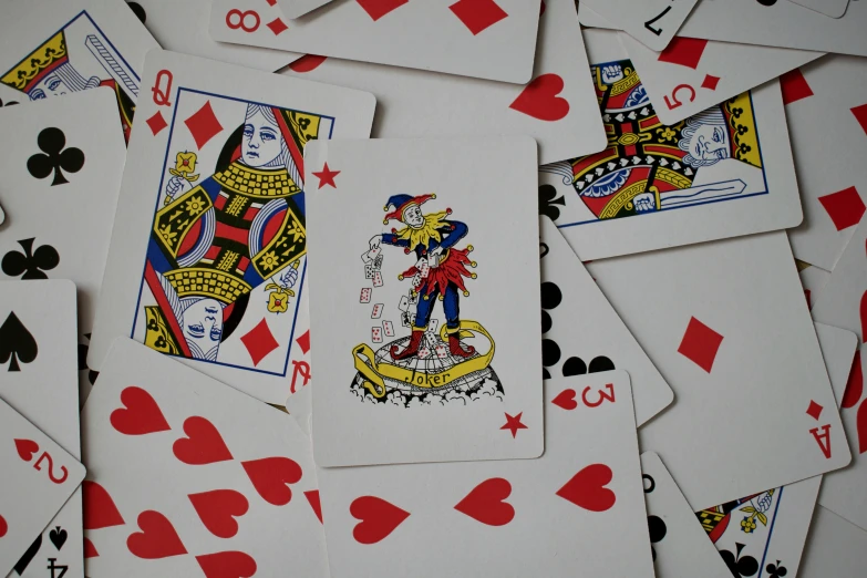 a table filled with playing cards all made up of different shapes and sizes