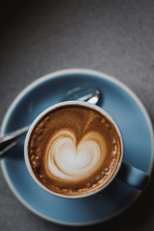 a cup of coffee with a heart shaped design
