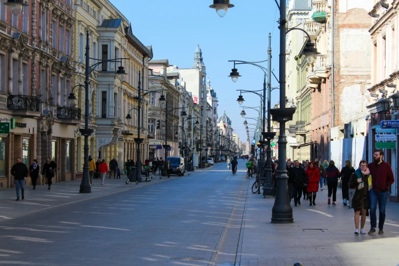 a busy city street with people walking on the sidewalk