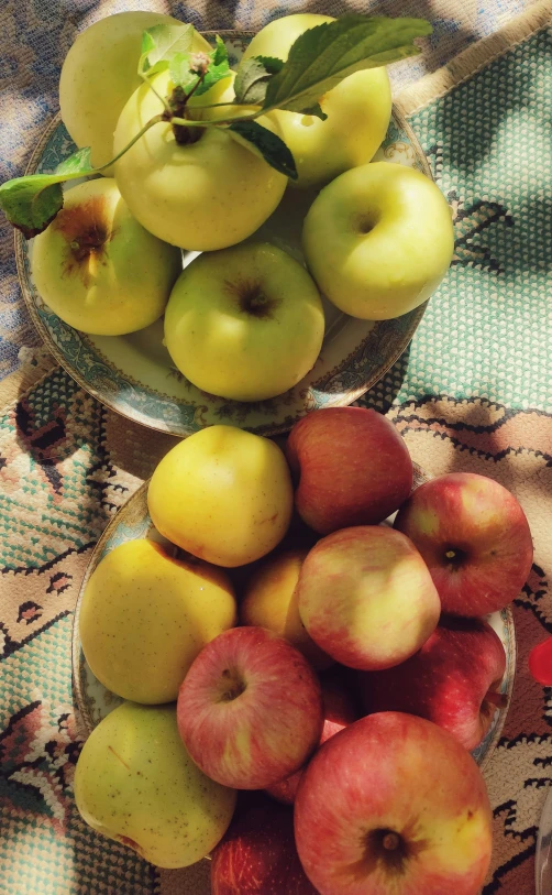 apples in small glass bowls on lace table cloth