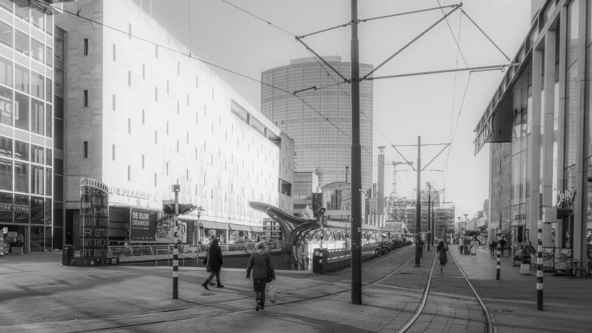 a train going past some people in the street