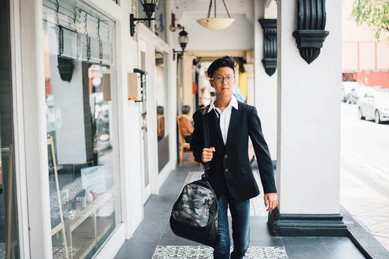 a man walking down the street carrying his handbag