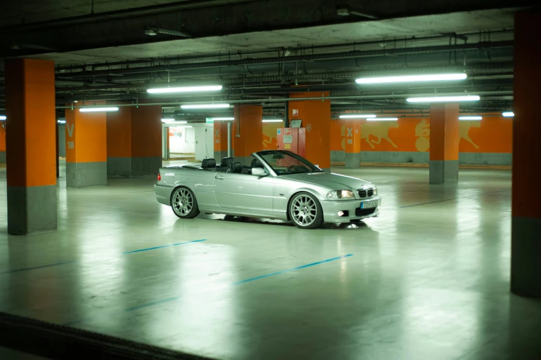 a silver car in an empty parking garage