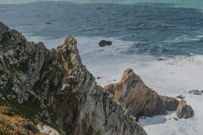 a couple of large cliffs sticking out of the ocean