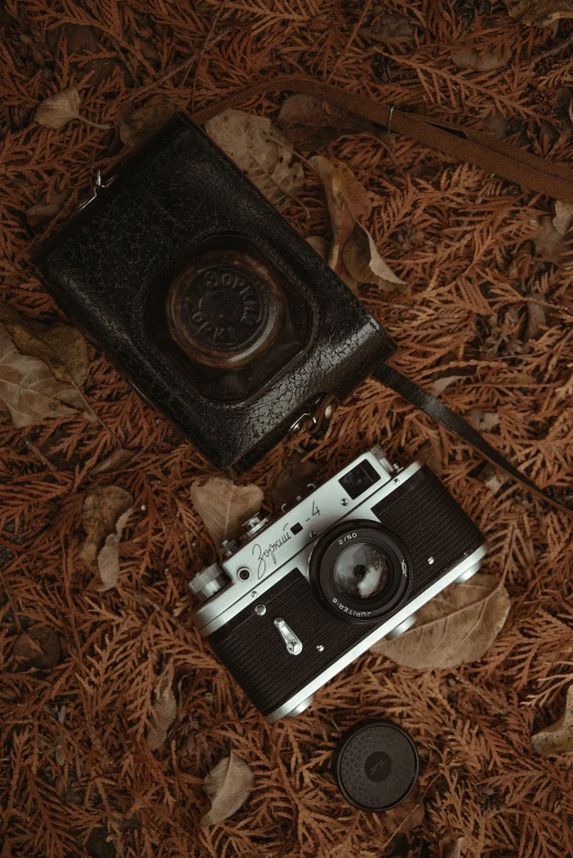 an old camera is laying out on the ground