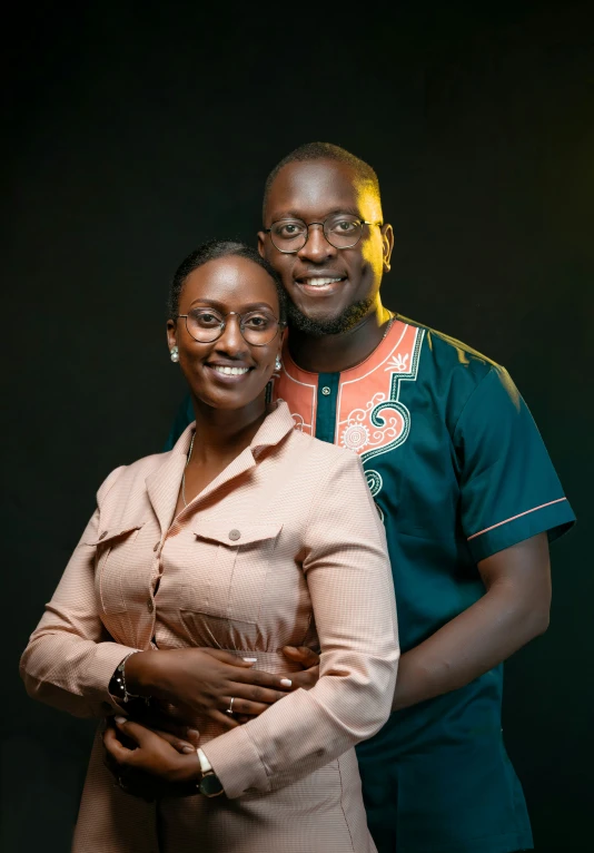 an african couple pose for a portrait while standing together