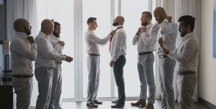 some men standing together in suits and ties