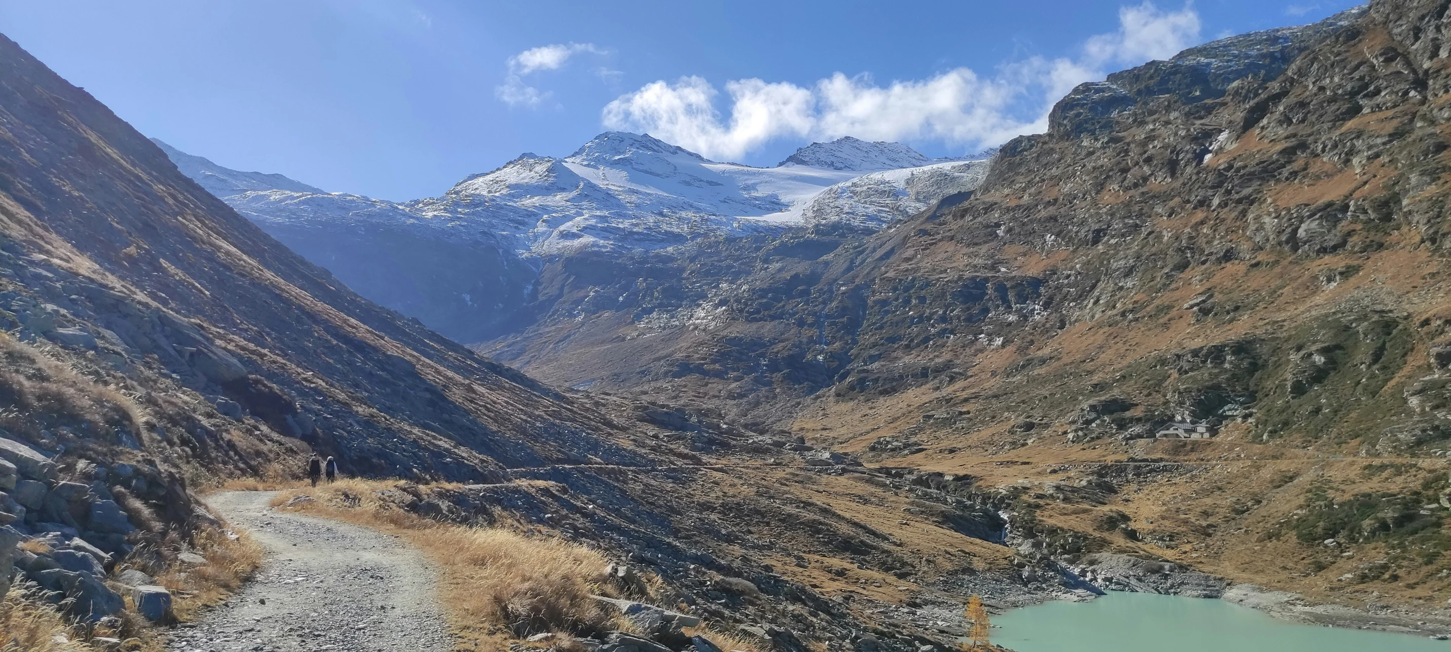 a scenic view of a mountainous valley and water