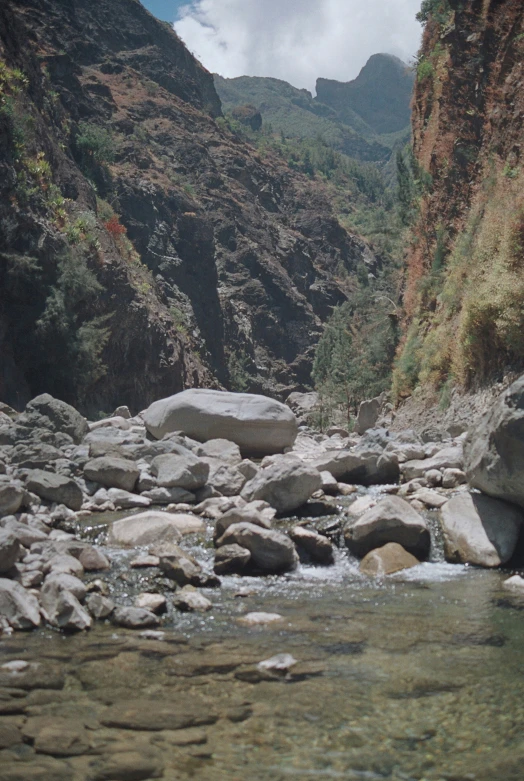 a river cuts through a rocky mountain valley