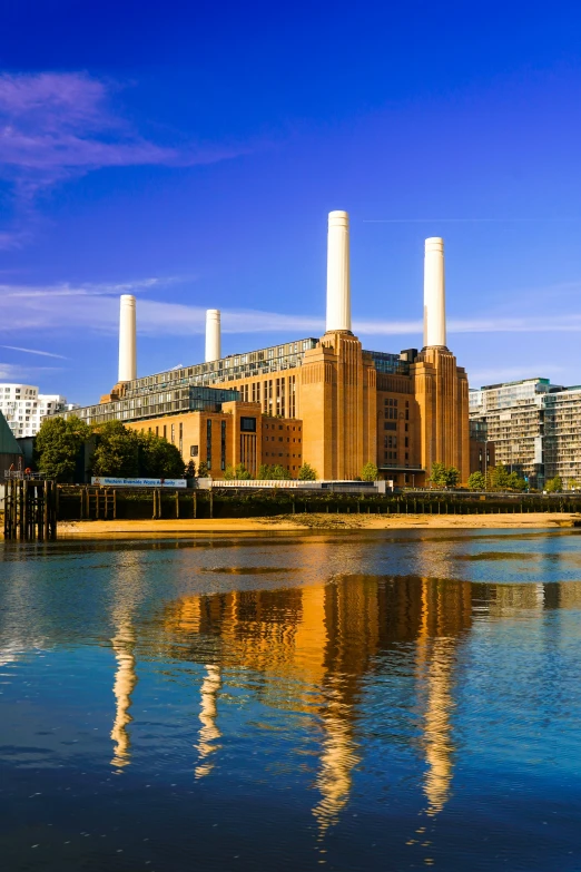 water and a power station with city buildings in the background