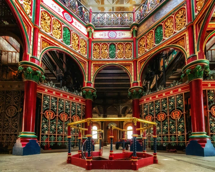 the inside of a building with red pillars and brightly painted details