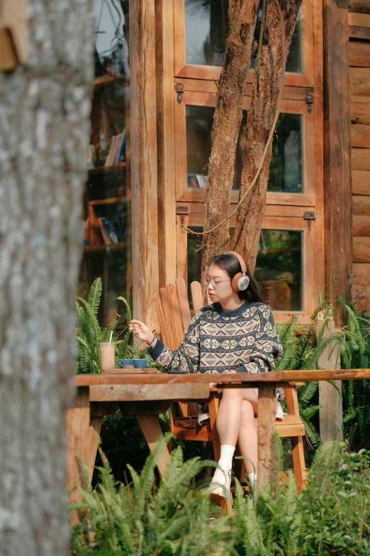 a person sitting on a bench with her phone