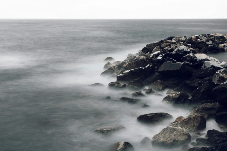 a po taken of the ocean with rocks and waves in it