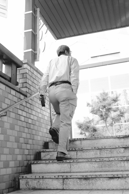 black and white pograph of a man walking down the stairs