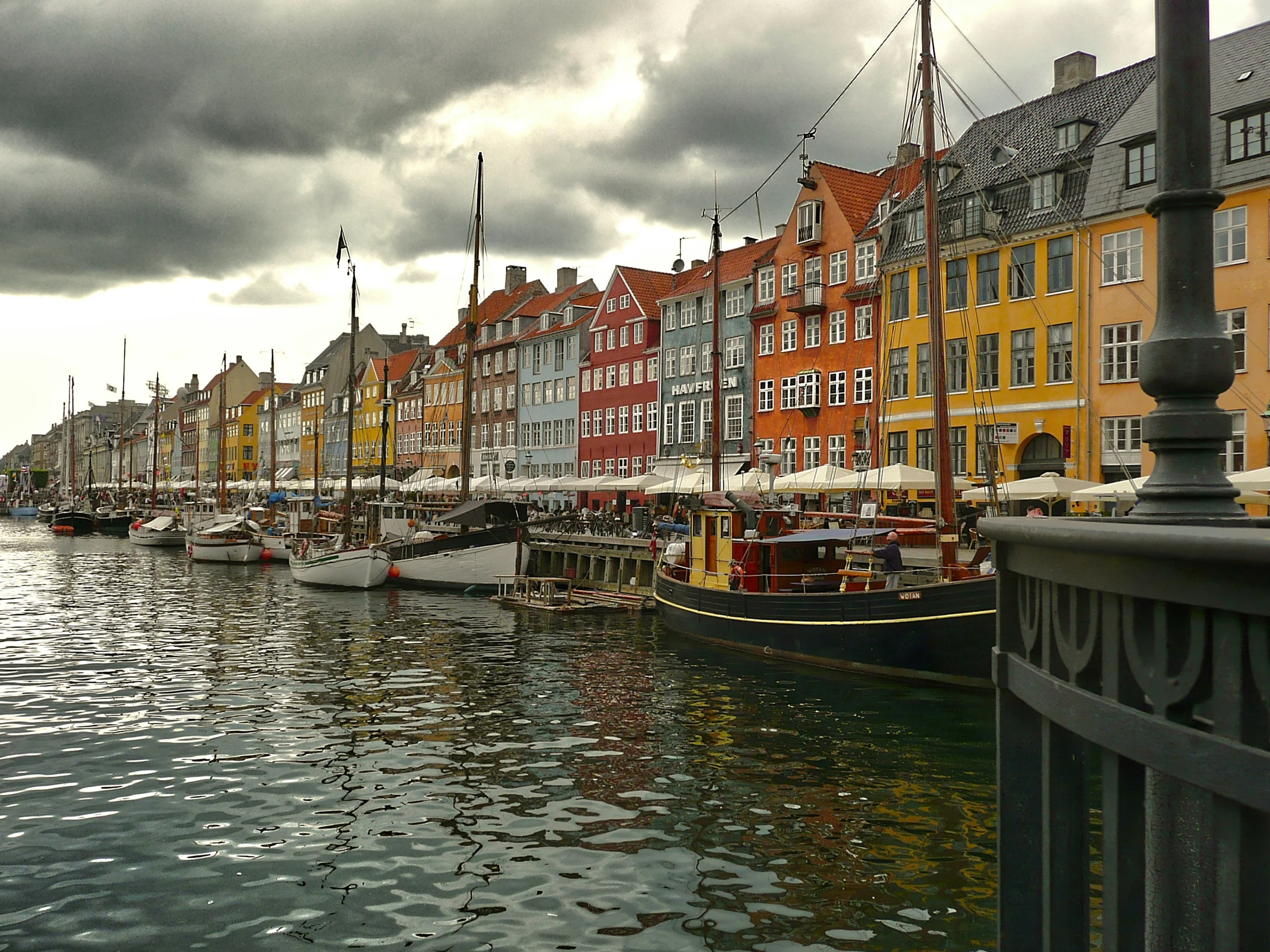 a row of boats docked next to buildings