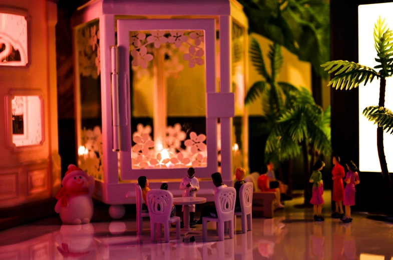 a small doll house setting with a lit up fireplace