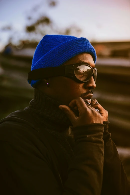 a man wearing glasses while talking on a phone