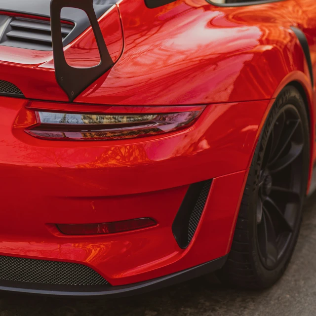 a red sports car is shown with its hood up