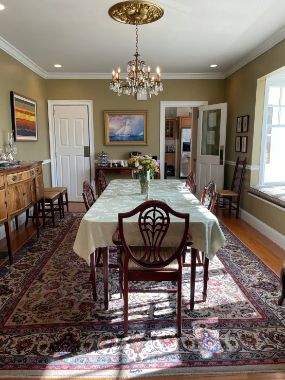 a formal dining room with an intricate rug on the floor