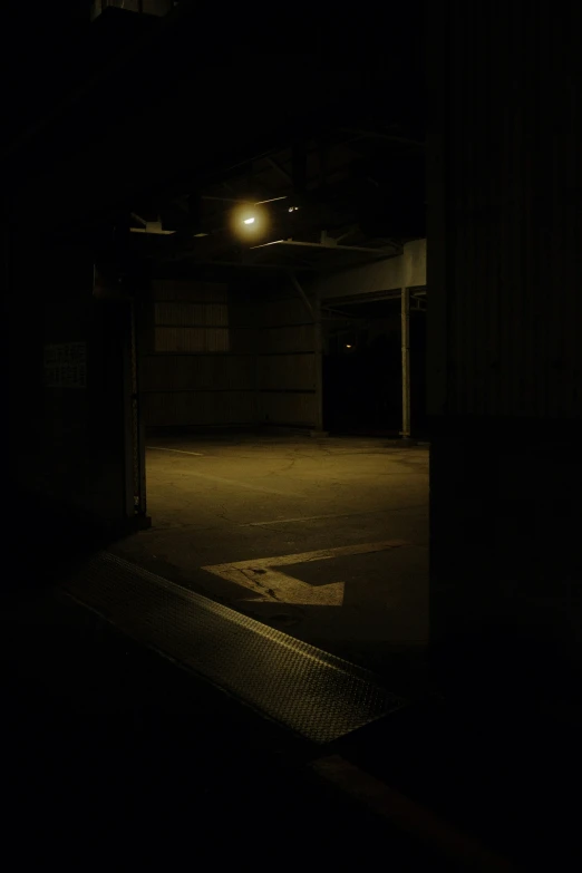 a parking lot with a street sign at night