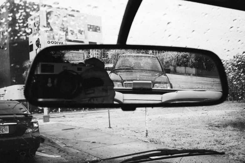 a picture taken from a passenger's side mirror on a car of an old car