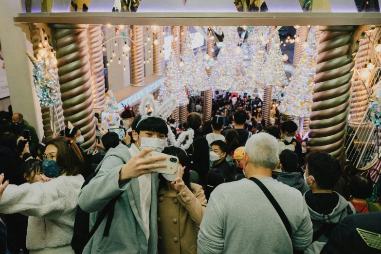 a large crowd of people all around the escalator