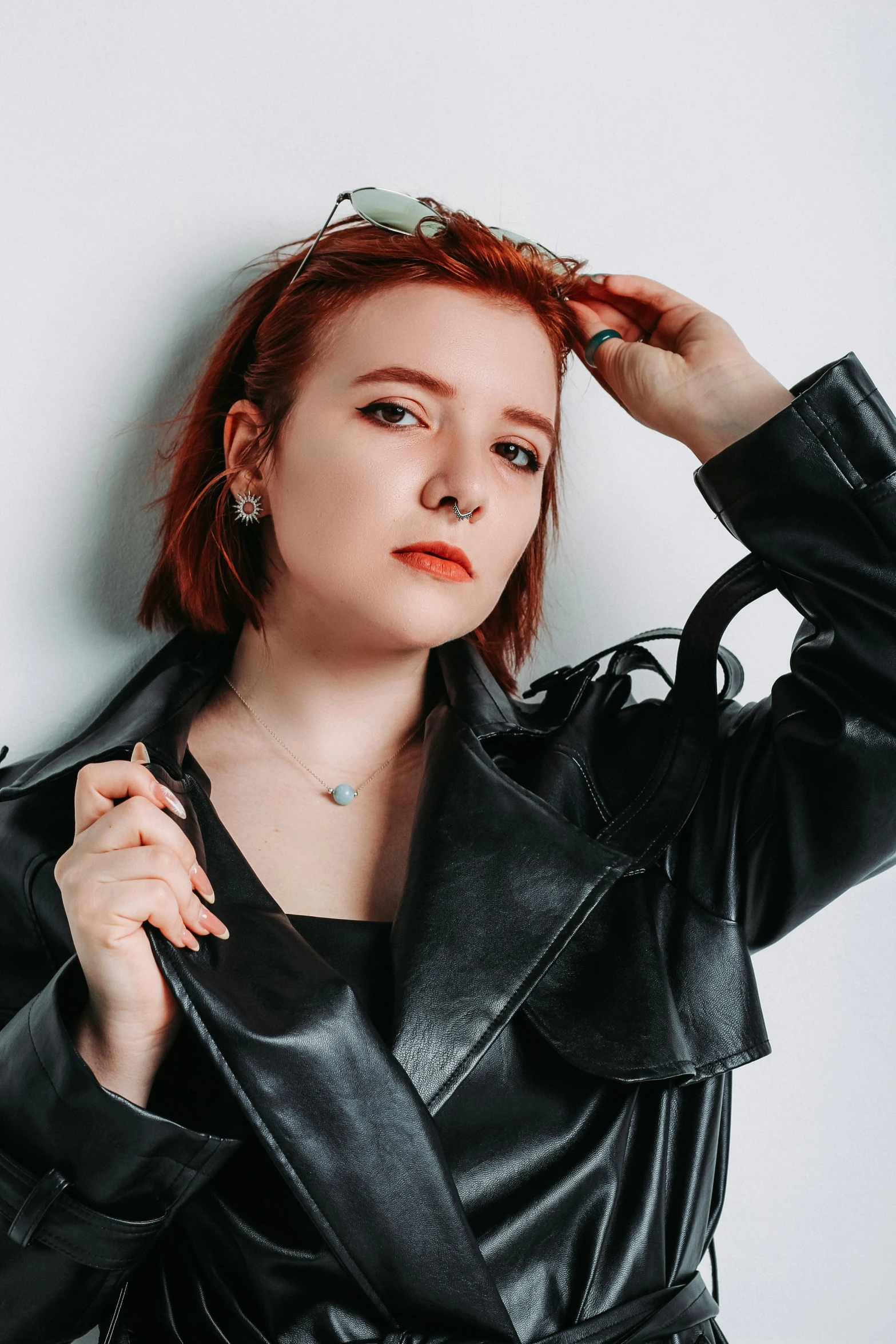 a young lady wearing a black jacket posing