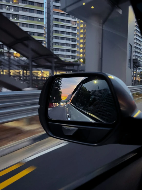 a rear view mirror of someone driving a car