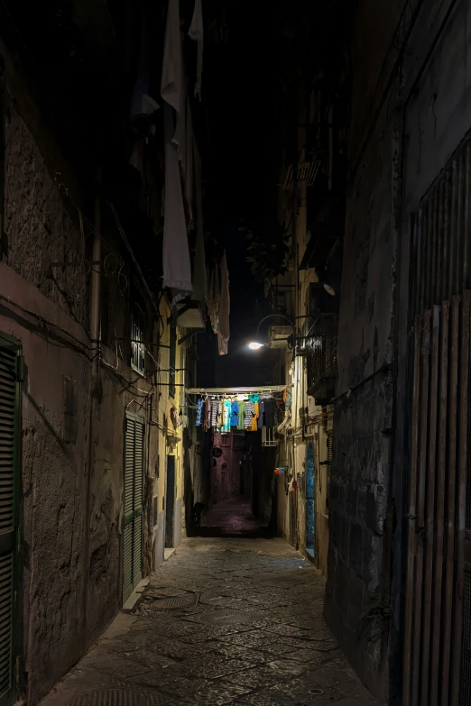 alley way in a city at night with light