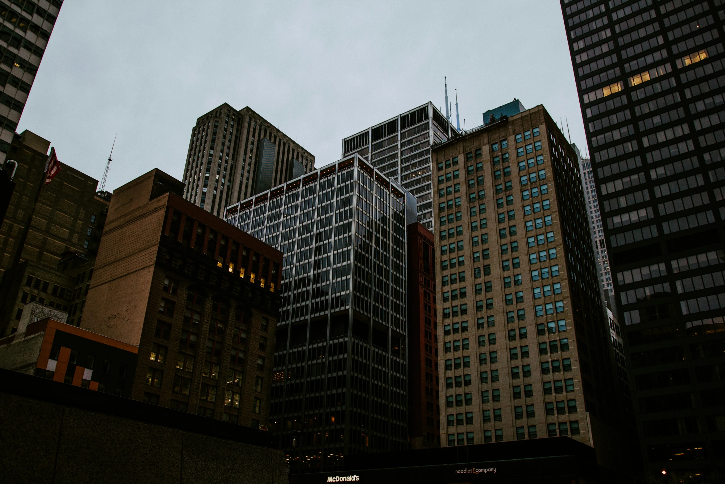 looking up at tall buildings in a downtown area