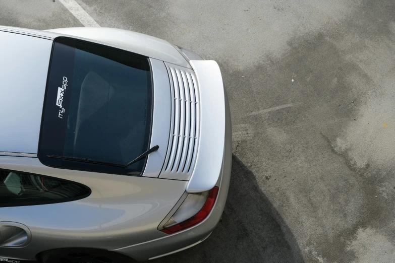 a silver sports car parked in a lot