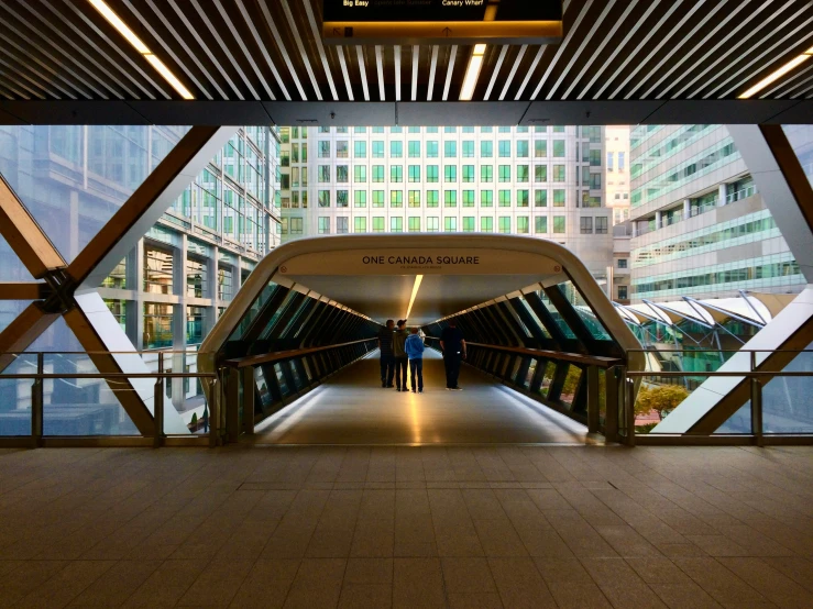 a view from the sidewalk into a walkway with lots of building on both sides