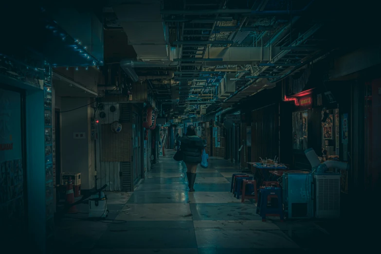 a man walks down an alleyway in the dark