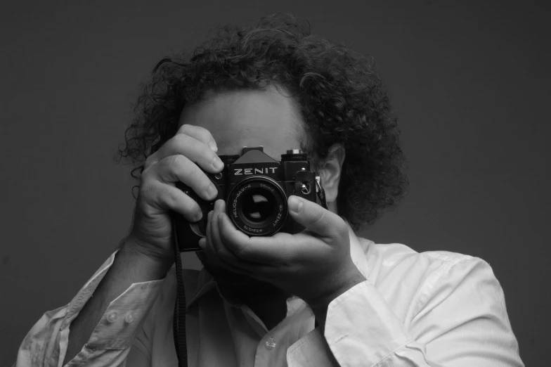 a black and white po of a woman holding a camera