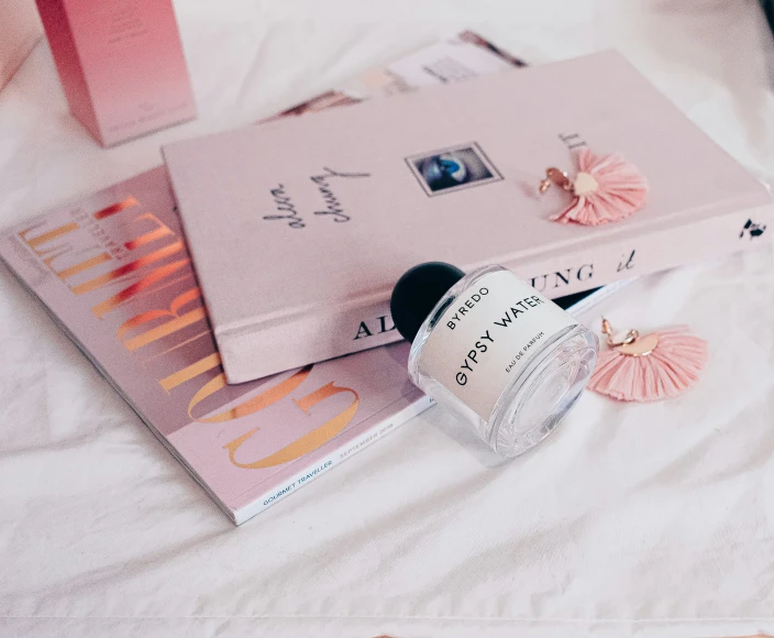 the pink books and the ring are laying on top of each other