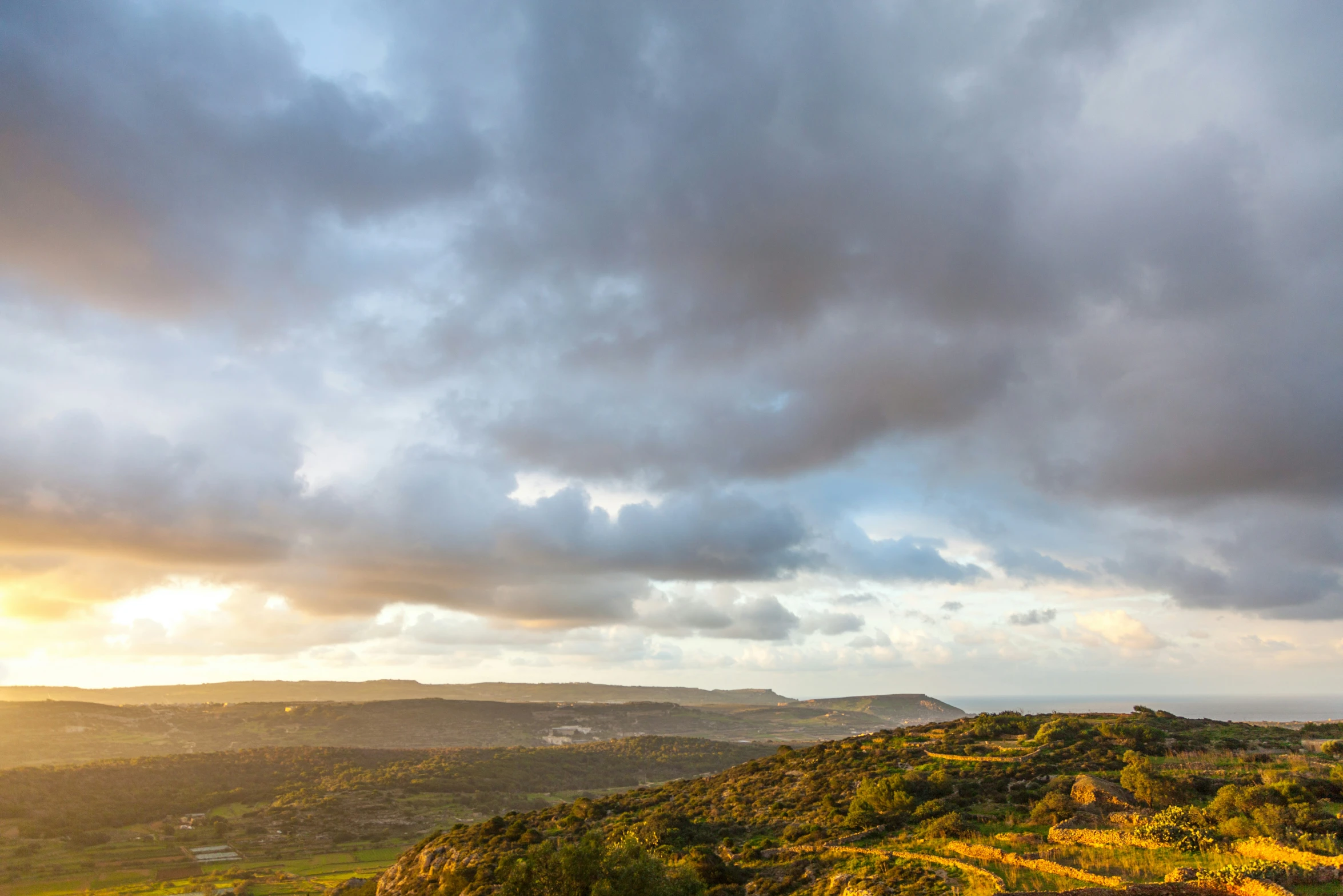 a scenic picture of a mountain overlook with storm clouds