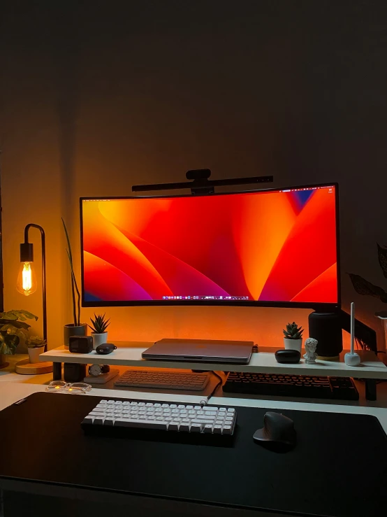 a monitor sitting on top of a desk next to a keyboard