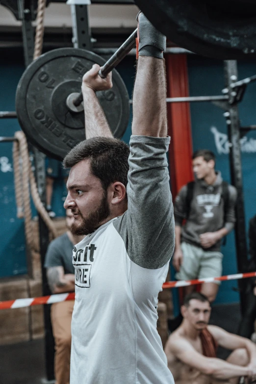a man lifting a heavy weight bar in front of his head