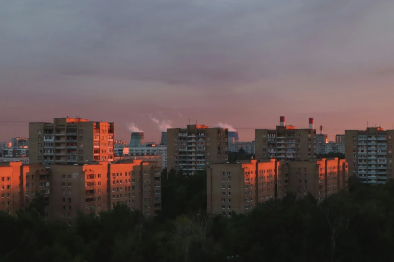 the city is very tall with many red smoke stacks rising from them