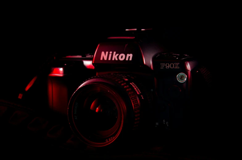 a camera with its flash light on and the name nikon visible