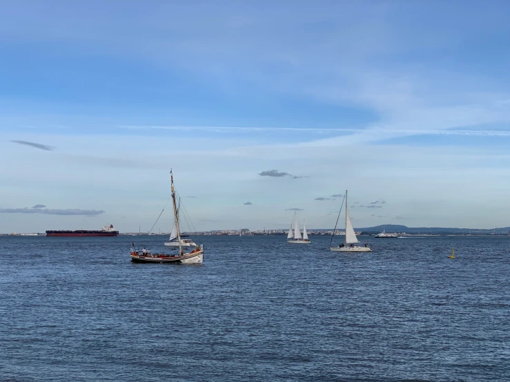 sailboats are in the water at a distance