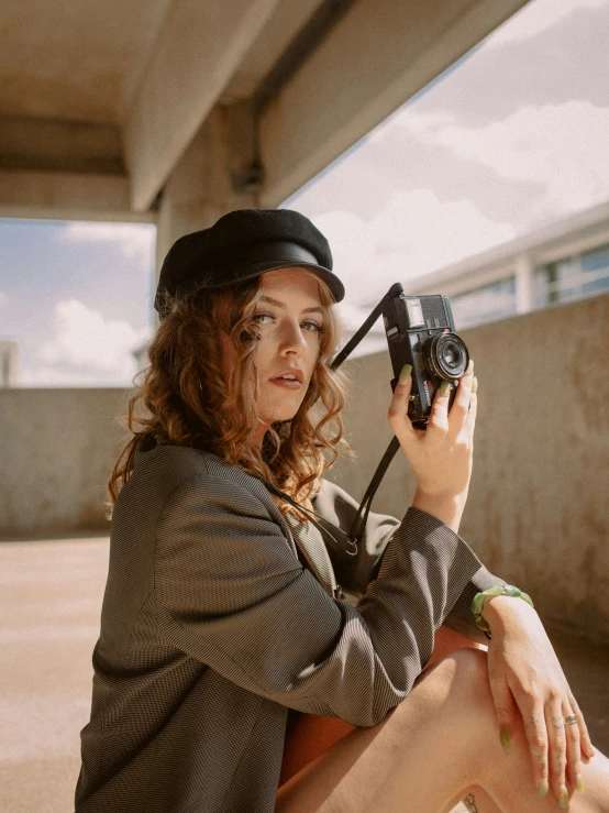 a young woman sitting on the floor taking pictures